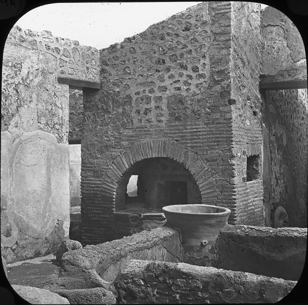 V.3.8 Pompeii. Looking south-east across bakery towards oven.
Photo by permission of the Institute of Archaeology, University of Oxford. File name instarchbx202im 062. Source ID. 44551
See photo on University of Oxford HEIR database