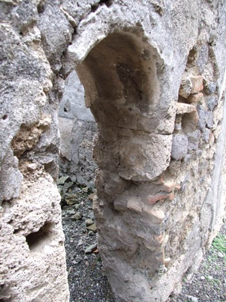 V.3.8 Pompeii. December 2007. Arched doorway into latrine on east side of andron.