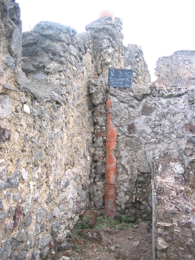 V.3.10 Pompeii. July 2008.
Looking south towards latrine and downpipe from an upper floor latrine. Photo courtesy of Barry Hobson.