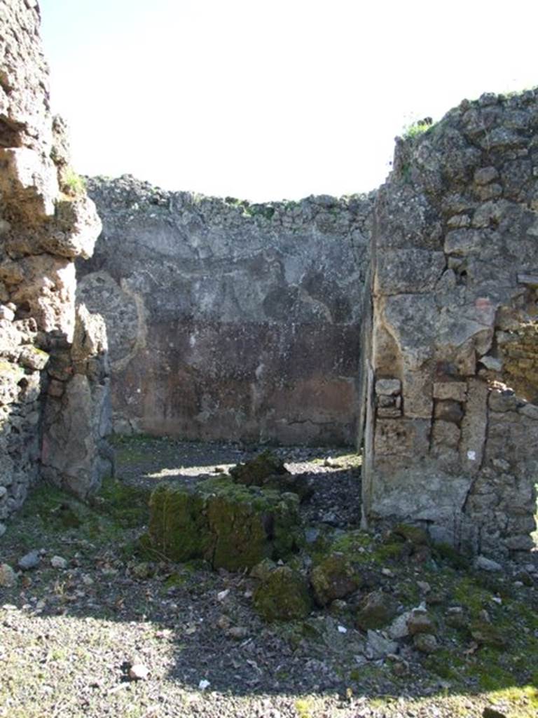 V.3.11 Pompeii. March 2009. Doorway to triclinium, in south-east corner of atrium.
According to NdS, this large room was decorated with a yellow dado separated by bands of imitation variegated marble. In each of the upper panels was a small bronze-coloured painted figurine, sphinx, griffin, peacock, or harpy. In two places the walls were irregularly holed, as occurred many times by those fleeing the eruption or by searchers in the buried city. For these holes in the walls, a system had now been adopted. If they did not compromise the stability of the wall, they were left as they were, facing only the edges with cement. In the opposite case, they would be blocked up, inserting a marble slab engraved with the year of restoration. See Notizie degli Scavi, 1902, (p.371)
According to Bragantini, the dado was black, and the middle zone was yellow with panels.
See Bragantini, de Vos, Badoni, 1983. Pitture e Pavimenti di Pompei, Parte 2. Rome: ICCD. (p.79, ambiente (C))