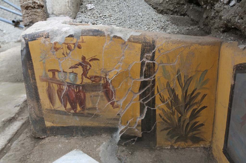V.3 Pompeii. March 2019. Thermopolium at the crossroads between Vicolo delle Nozze d’Argento and Vicolo dei Balconi. 
This side of the counter is most probably the illustration of the business conducted in the shop, almost as if it were a shop sign. 
The discovery of amphorae during excavation, which were located in front of the counter, reflected the painted image exactly.

V.3 Pompei. Marzo 2019. Termopolio all'incrocio tra il Vicolo delle Nozze d'Argento e il Vicolo dei Balconi.
Le decorazioni del bancone raffigurano su un lato, l'illustrazione, molto probabilmente, dell'attività stessa che si svolgeva nella bottega, quasi come un'insegna commerciale. 
II ritrovamento di anfore paste davanti al bancone, al momento dello scavo, rifletteva difatti esattamente l'immagine dipinta.

Photograph © of Parco Archeologico di Pompei.
