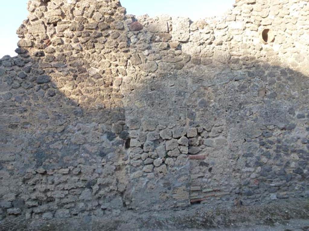 V.4.1 Pompeii. June 2012. Looking east in Vicolo di M L Frontone towards side wall. Photo courtesy of Michael Binns.