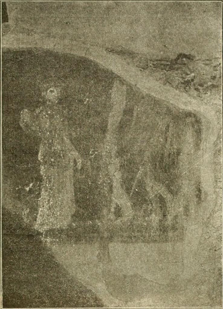 V.4.6/7 Pompeii. Painting of Maenad with Bacchus. The background was red.
On the right was Bacchus, but his head was missing from the painting.
He poured the liquid from a jug into the mouth of his panther.
On the left we see a standing Maenad, crowned with ivy and dressed in green robe.
In her right hand she held a tambourine and a wand in her left.
See Notizie degli Scavi di Antichità, 1899, p. 345, fig 6.