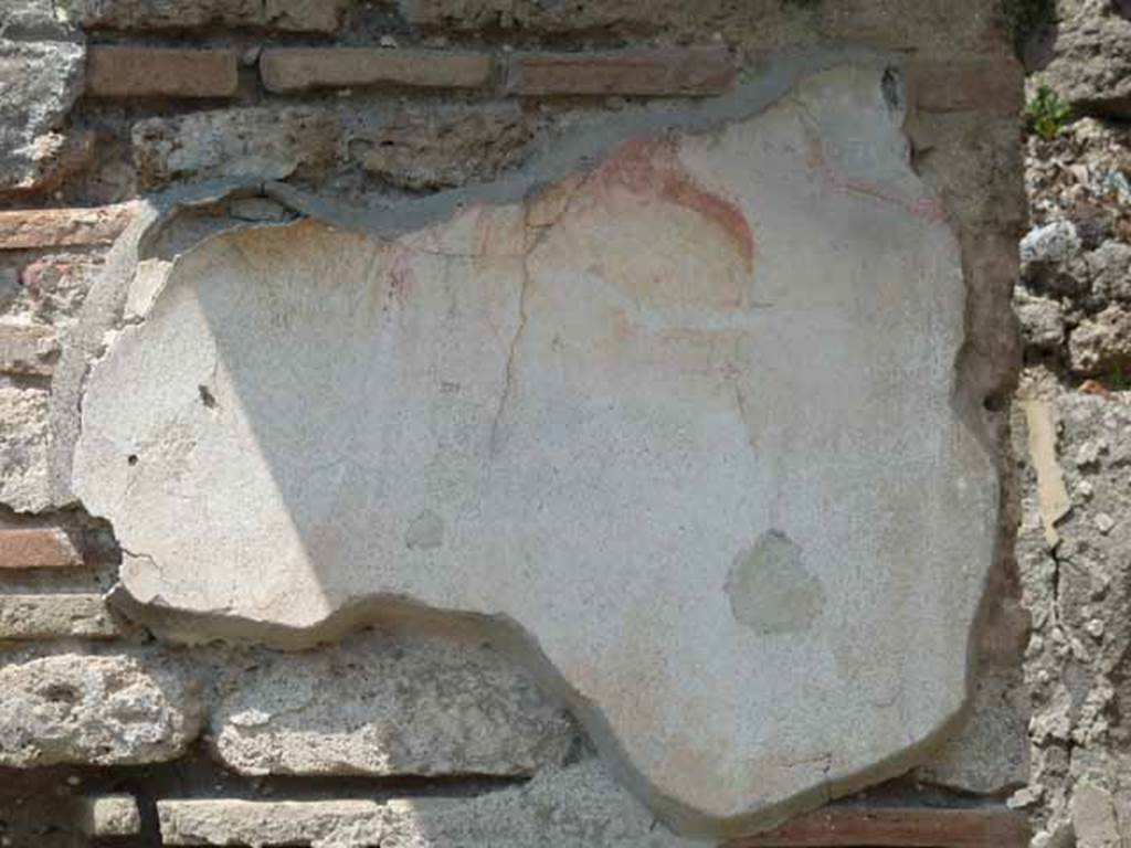V.4.7 Pompeii. May 2010. Remains of painted plaster on pilaster at rear of bar room behind counter. According to Stefani, there was a small painting of Bacchus and Silenus on the wall in the room. See: Stefani, G, curatore, 2005. Cibi e Sapori a Pompei e dintorni. Pompei: edizione Flavius. (p.101-2)