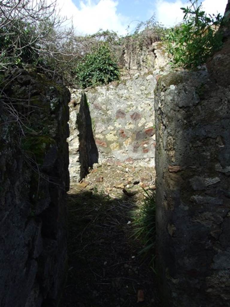 V.4.12 Pompeii. March 2009. Looking north through doorway to workshop area.