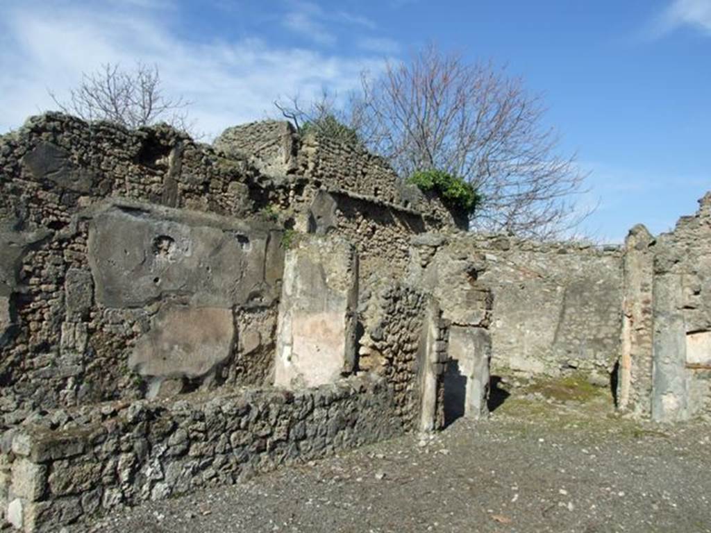 V.4.b Pompeii. March 2009. Exedra on north side of atrium. On the south side of the Exedra, would have been another small room and staircase to upper floor. On 16th September 1943 a bomb fell here, destroying the prothyron, the atrium and some rooms to the north.
