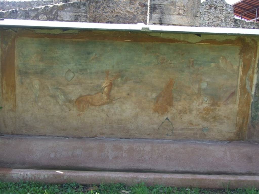 V.5.3 Pompeii. March 2009. Room 7, painting on west side of peristyle –
Painting 6 - Animal painting showing to the right, a bear standing on his rear legs eating the fruits from a tree. Then to the right, near a bridge, a statue of Priapus near to which was a round altar. On the left, a deer being pursued by a dog. See Not. Scavi, 1899, p.349, number 4.