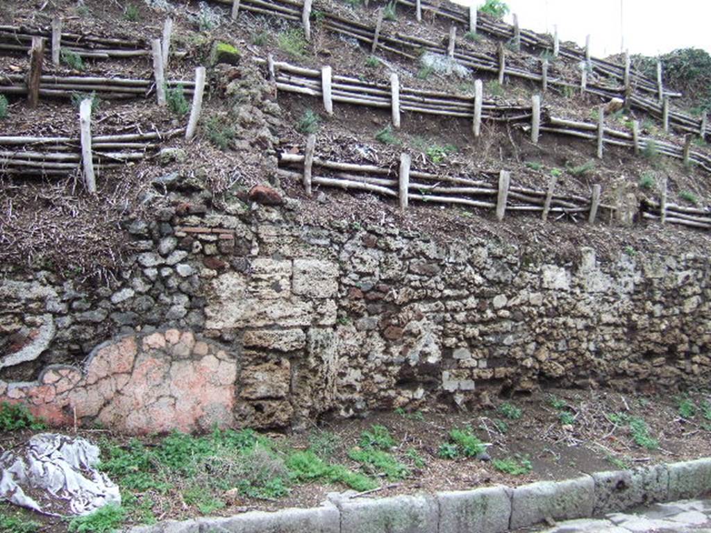 V.6.8, (on left with remaining pink plaster) and V.6.7, Pompeii (on right). December 2005.
Unexcavated façade on east side of roadway.