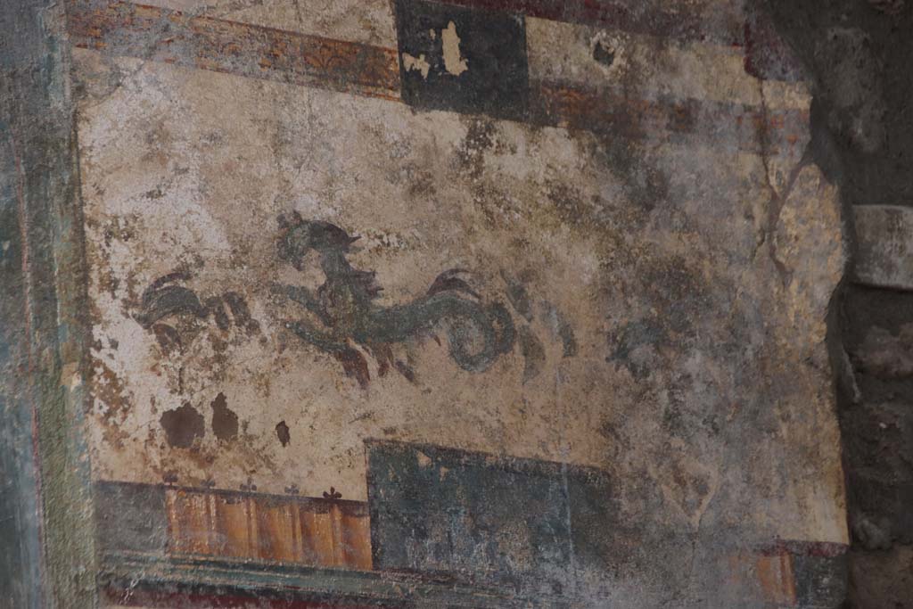 V.6.12 Pompeii. October 2020. Detail of dolphin and marine animal from upper panel on east side of central painting of Priapus.
Photo courtesy of Klaus Heese.