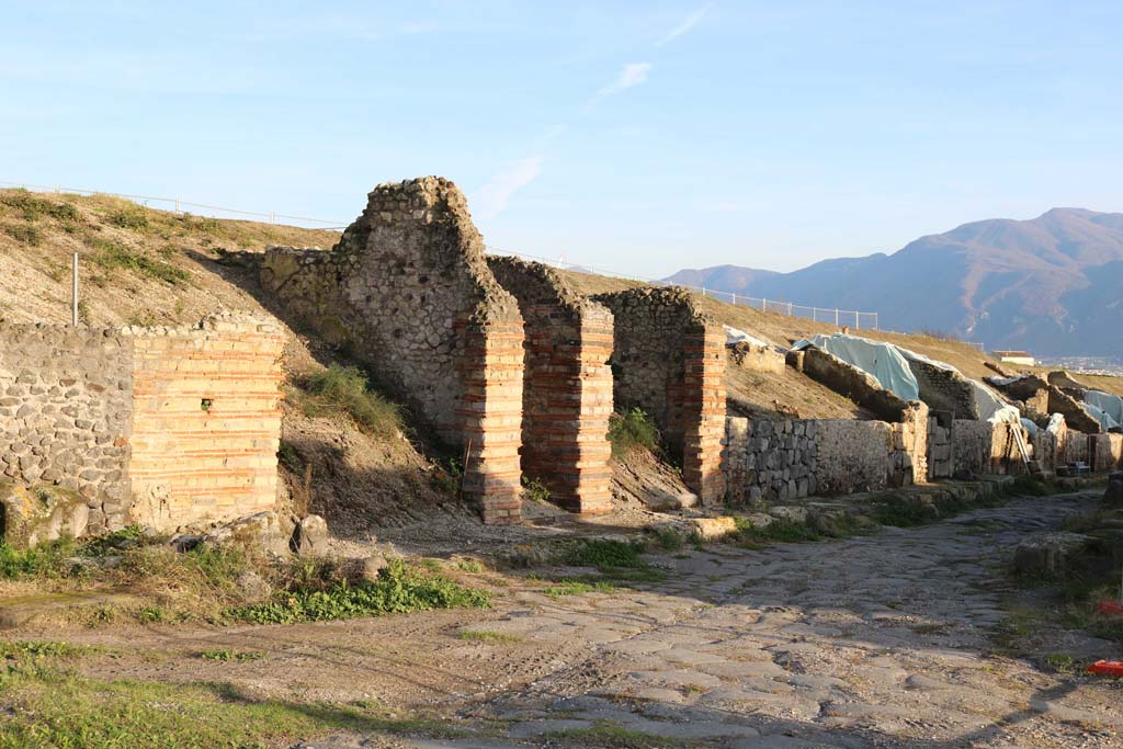 V.6.18, V.6.17 and V.6.16, on east side of Via del Vesuvio. December 2018.
Looking south-east to entrance doorways. Photo courtesy of Aude Durand