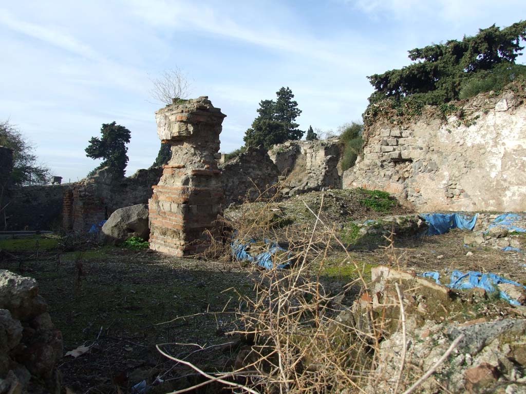 VI.1.1 Pompeii. December 2007. Looking north-west across garden area with triclinium (under blue sheeting), from VI.1.4.
According to Soprano –
Ubicazione: giardino. L. medius, m.3.95; l. imus, m.4.00; l. summus, m.3.75.
Bibliog. Bonucci, A., Pompei descritta (3 ed., Napoli, 1827), p.85; Mazois, F., Les ruines de Pompei, II. P.46. tav.ix. fig. 3 e 5;
Fiorelli, op. C., p.76; Dyer, Th. H., Pompeii (London, 1891), p.307, 308, e piante.
Era un grande triclinio ombreggiato da pergolato. Il Mazois afferma che “i fori nei quali riposavano le estremita dei travi destinati a sostenere la pergola sono perfettamente conservati”; attualmente essi non sono piu visibili che in parte, in seguito alla costruzione proprio sul l. summus di un muro di sostegno perpendicolare alla parete di fondo del giardino.
Il l. imus era piu lungo del l. summus; nessuno dei tre letti era addossato ai muri, il l. medius dista cm.50 dal muro di fondo, intonacato e con tracce di un pannello quadrato. Dalla descrizione del Mazois risulta che tutto il triclinio era rivestito di stucco e di pitture di esecuzione piuttosto rozza.
Manca la mensa.
See Soprano, P. (1950). I triclini all’aperto di Pompei. (In Pompeiana, raccolta di studi per il secondo centenario degli scavi di Pompei. Napoli, Gaetano Macchiaroli, Editore, P. 300, no.13).