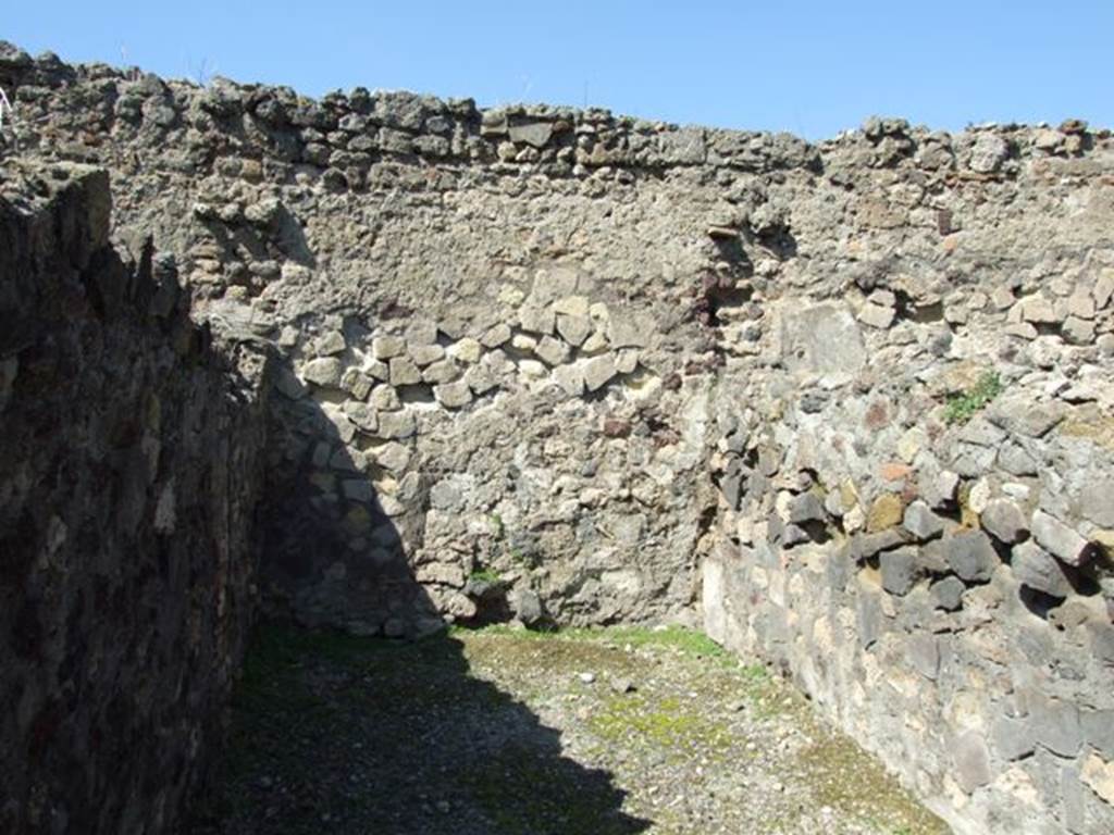 VI.1.2 Pompeii. March 2009. North wall of second room on north side.
On the left, in the shadow, was the toilet. According to Hobson, later this toilet was overlaid by a floor to allow the ground floor rooms to be used as work areas. The sleeping and residential rooms were moved to the newly constructed upper storey, to which the toilet facility was also removed. The down pipe from the upper storey which drained into the pit for this toilet was situated in a stone buttress on the northern aspect of the wall in VI.I.I, at the rear of this toilet. The buttress was built above the entrance to the cesspit. The excavation of the cesspit below the buttress, using long-handled tools, revealed a large amount of pottery, glassware, and some coins. Fortunately this cesspit was only 2.5m deep and could be completely cleared. It is possible that it had been used as a rubbish disposal pit, perhaps after the earthquake of 62CE. See Hobson, B., 2009. Latrinae et foricae: Toilets in the Roman World. London; Duckworth. (p.63)