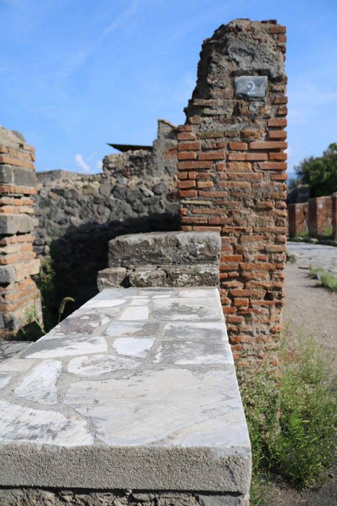 VI.1.2 Pompeii. December 2018.
South side of entrance doorway, counter and shelving. Photo courtesy of Aude Durand.