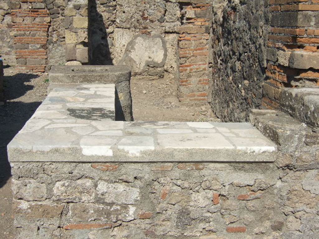 VI.1.2 Pompeii. September 2005. Counter with marble top, hearth and display shelves.