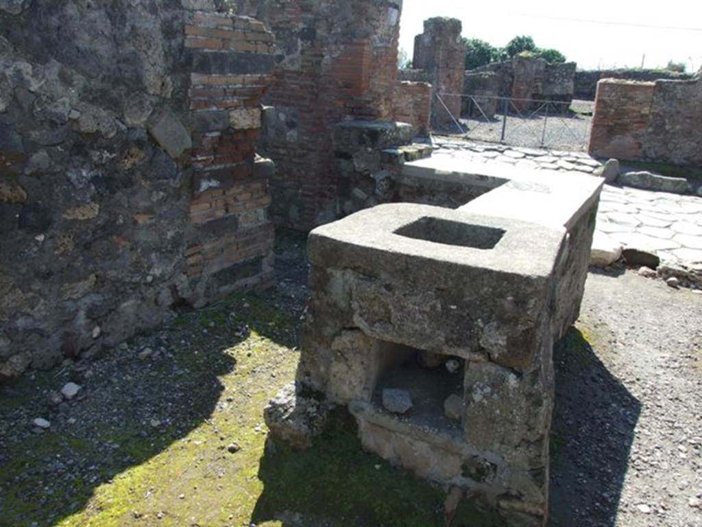 VI.1.2 Pompeii. March 2009. Looking west across hearth and counter to Via Consolare.