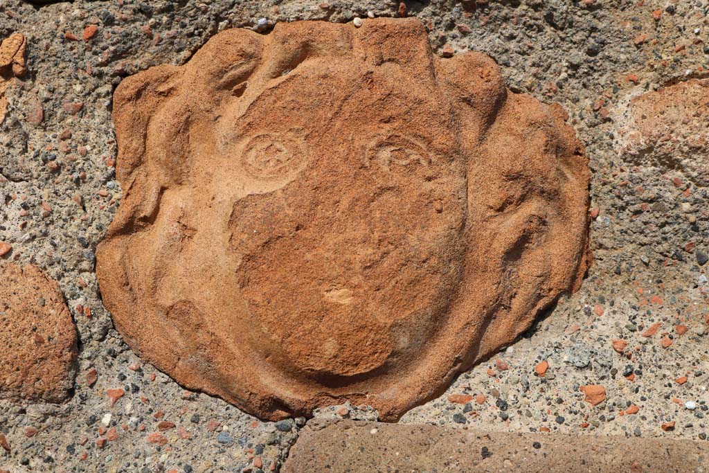 VI.1.4 Pompeii. December 2018.
Terracotta mask of head embedded in masonry on south side of entrance doorway. Photo courtesy of Aude Durand.