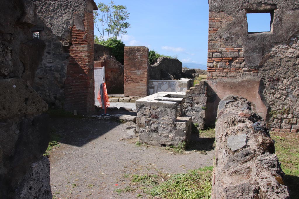 VI.1.5 Pompeii. May 2024.
Looking west along north side towards counter and entrance doorway. Photo courtesy of Klaus Heese.