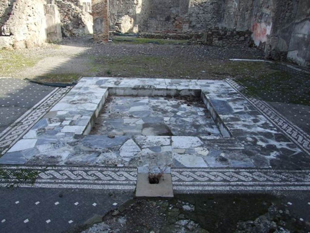 VI.1.7 Pompeii. December 2007. Impluvium in atrium, looking east.
According to Garcia y Garcia, this house was badly hit by the bombing on the terrible night between the 14th and15th September 1943, above all in the north-east section with the entrance at number 25. It also suffered the destruction of the atrium and part of its mosaic floor, and the total destruction of the tablinum and two rooms on its north side.
Fallen and partially lost was the wall of the west portico, decorated with splendid motifs of the IVth Style. Entering the house at number 25, the stairs to the right (north side) and a good part of the north wall of the atrium has now disappeared.
See Garcia y Garcia, L., 2006. Danni di guerra a Pompei. Rome: L’Erma di Bretschneider. (p.66)