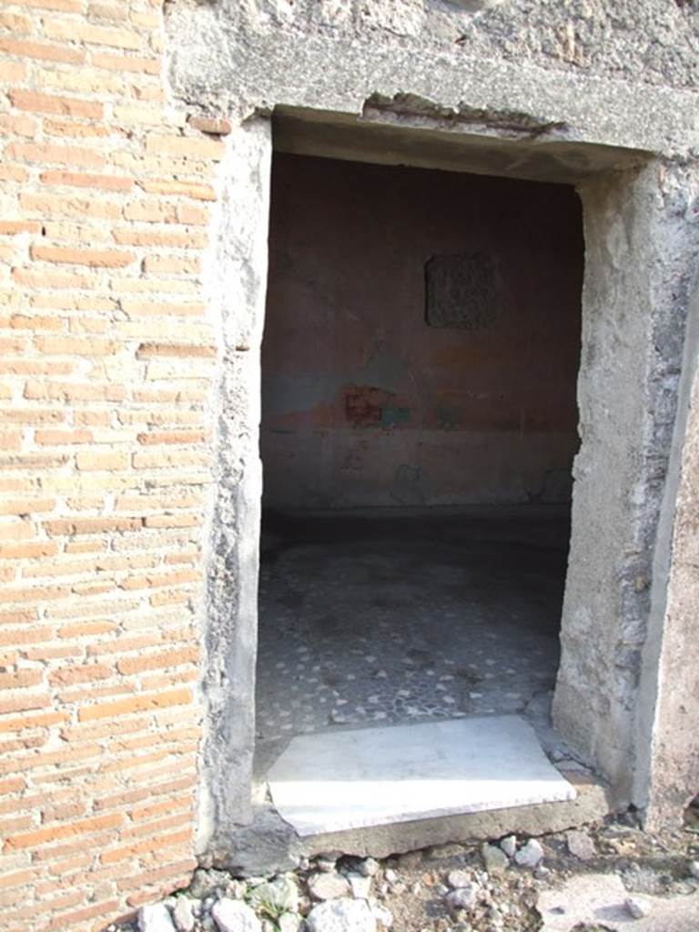 VI.1.10 Pompeii. December 2007. Doorway to room 9. Room to south of garden. Mau identified the room at the rear, to the right of garden, with window opening onto the garden as the only room with paintings of interest: A man sitting with a writing tablet in his hand, opposite him were 2 girls, one sitting, the other standing; the latter held a roll of papyrus, p.281, Same room, another panel, which was transferred to Naples Museum: A young woman was represented as painting a herm of Dionysus; a cupid was holding the unfinished picture while she mixed colours on her palette. Two other maidens were watching the artist with unfeigned interest, etc , p.282, figure 133,
The room contained a third picture, which is now almost obliterated.
See Mau, A., 1907, translated by Kelsey F. W. Pompeii: Its Life and Art. New York: Macmillan. (p.280-2, T. 133).
Helbig identified:
Room to the right of the garden, God and 2 girls, 1459
Room near peristyle, Painting of Girl, 1443
Maybe in the prothyron, Bust of a Girl, 1427b
See Helbig, W., 1868. Wandgemälde der vom Vesuv verschütteten Städte Campaniens. Leipzig: Breitkopf und Härtel. (1459, 1443, 1427b).