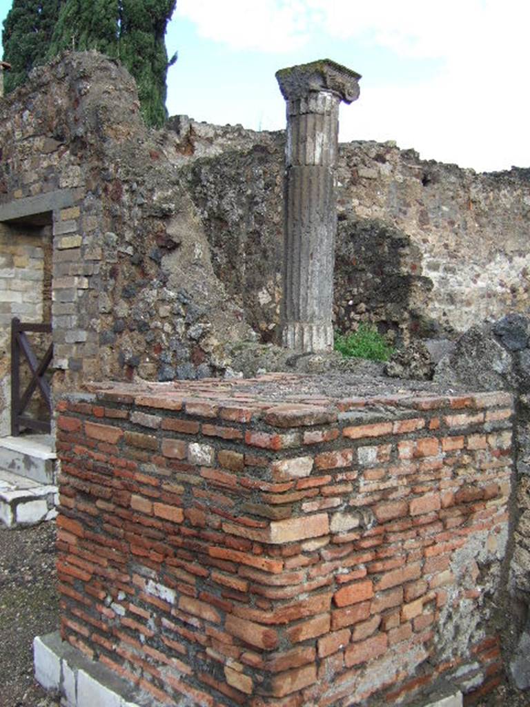 VI.1.13 Pompeii. May 2006.
Looking towards south side of marble clad pedestal or statue base, and doorway to VI.1.22, on left.