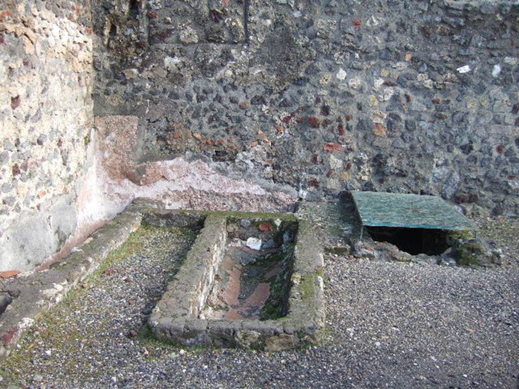 VI.1.15 Pompeii. December 2005. East wall with basins or vats.
According to Jones and Robinson, a group of small workshops were constructed in the south of the insula. Each workshop had a wide shop doorway opening onto Via Consolare. Plaster-lined tanks, similar to those found in the north of the insula, were recovered from the excavations of the Soap Factory (VI.1.14/15). They were also discovered at the Bar of Acisculus (VI.1.17) and also from the Shrine at VI.1.13. This suggested that there was a consistent phase of tank-centred industrial activity throughout the insula, and that fish processing was a major industry in this area of Pompeii during the late second and early first centuries BC.
See Dobbins, J & Foss, P., 2008. The World of Pompeii. New York: Routledge. (p.394)
On page 398, they say that following the Social War, the fish processing tanks were abandoned and the workshops redeveloped. In the Soap Factory, a group of clay and stone hearths were recovered, along with significant quantities of hammerscale, charcoal, slag and hearth bottoms. This property was now operating as a metal smithy.