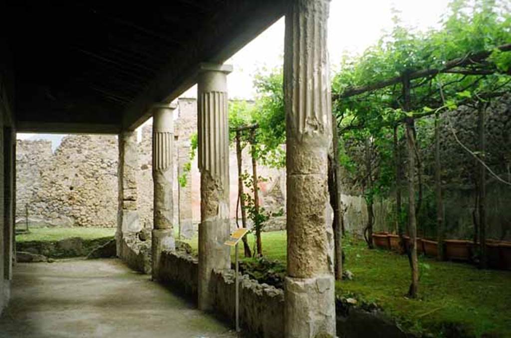 VI.2.4 Pompeii. May 2010. Looking north across portico and garden towards summer triclinium. Photo courtesy of Rick Bauer. According to Jashemski, this narrow raised garden, excavated 1806-9, had a colonnaded portico on the west supported by four columns and one pillar. The adjacent part of the garden on the north, originally had a similar colonnade, but this was later enclosed to make rooms. In the north-east corner was a masonry triclinium shaded by a vine covered pergola. This triclinium is unusual because the couches are level.
A shallow marble pool (15cm deep) occupied the space between the three couches. In the centre of the pool was a monopodium which supported a marble table. The table was destroyed. Near the wall was a masonry altar. See Jashemski, W. F., 1993. The Gardens of Pompeii, Volume II: Appendices. New York: Caratzas. (p.121)