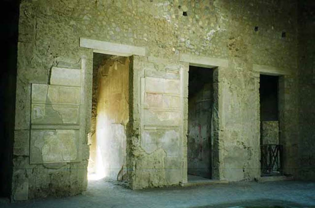 VI.2.4 Pompeii. June 2010. South side of atrium, looking south-west.
The doorway on the left leads through to the garden apartments. The central doorway is into a cubiculum. Photo courtesy of Rick Bauer.