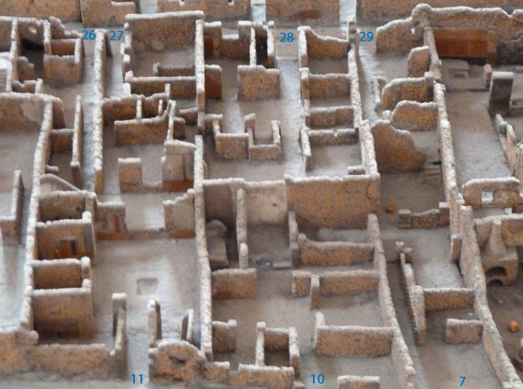 VI.2.7 Pompeii, can be seen on the right. May 2010. Looking east. Model as viewed in Naples Archaeological Museum. According to the model, in the south-east corner of one of the rear rooms, as in photo above this one, there used to be steps.