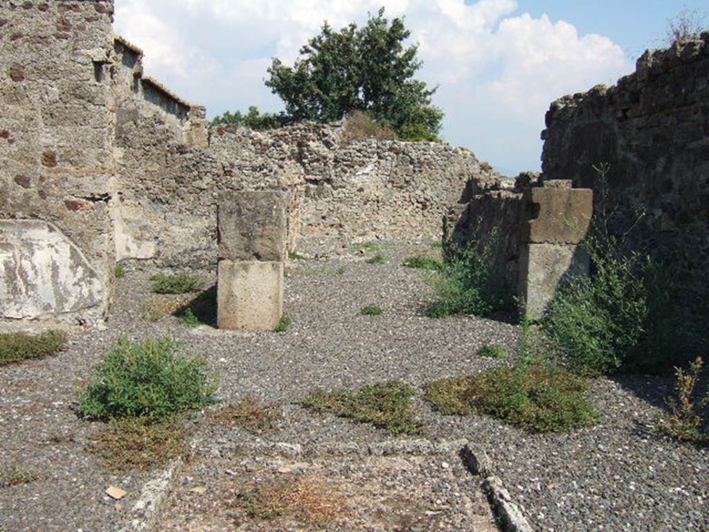 VI.2.12 Pompeii. September 2005. Room 2 atrium, looking east towards room 5, tablinum.
Room 6 is on the left and corridor 4 on the right of the tablinum.