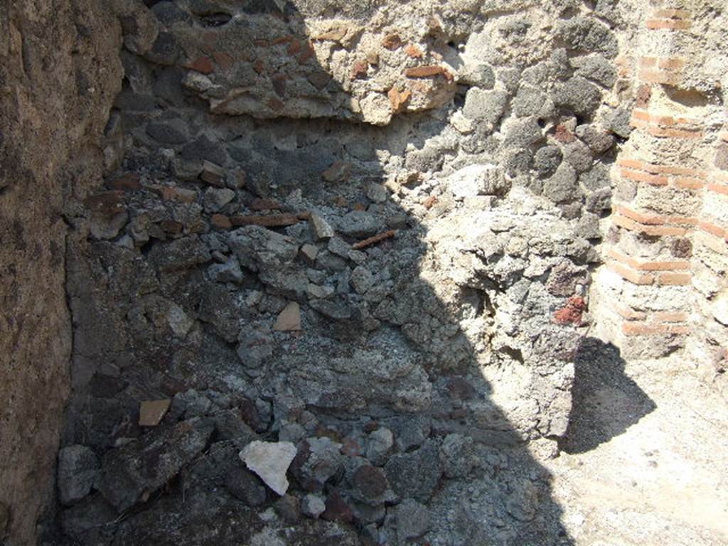 VI.2.12 Pompeii. September 2005. Room 10. Kitchen north-west corner. Remains of hearth?