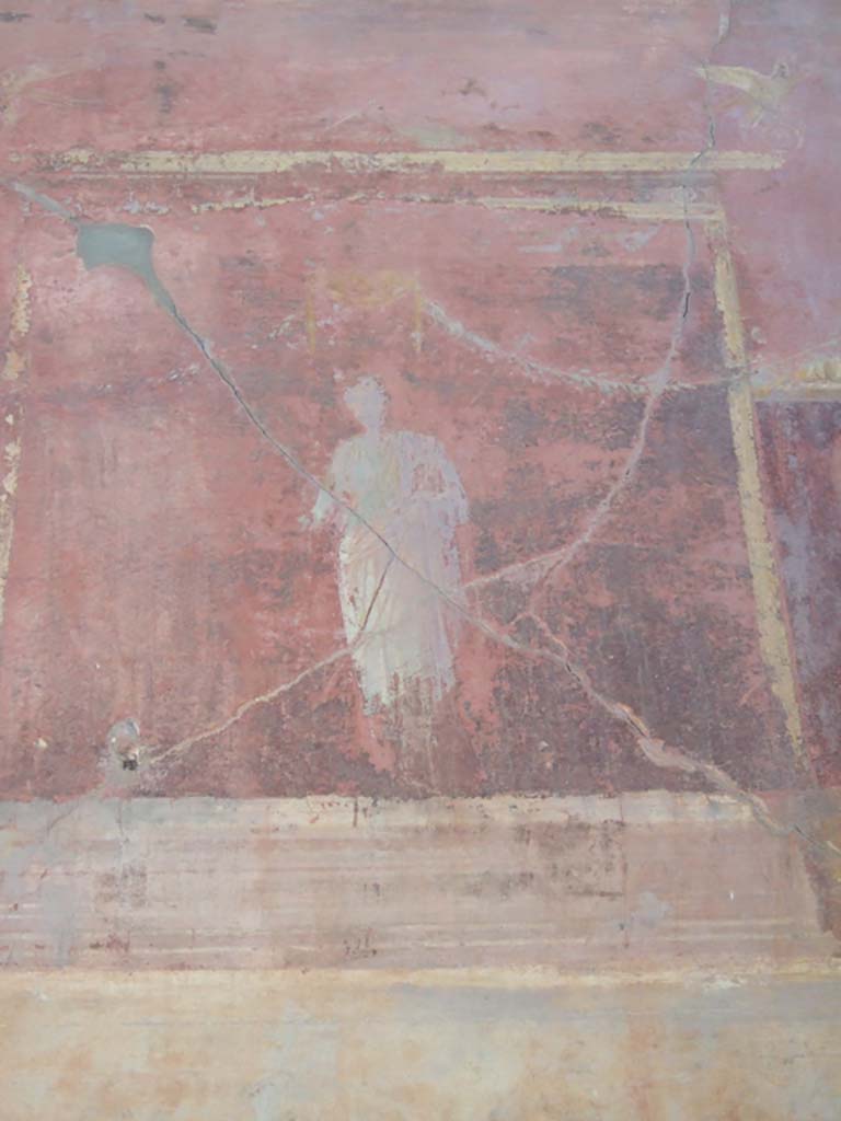 VI.2.14 Pompeii. September 2005.
Triclinium, detail from painted upper west wall, central figure above blue panel.