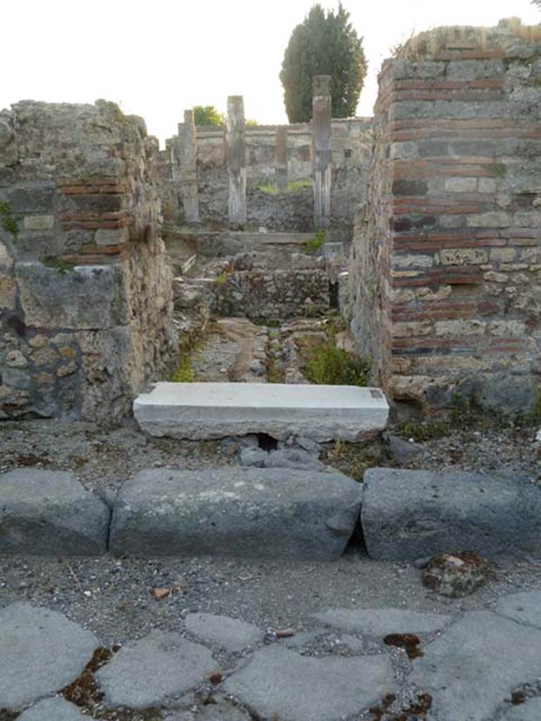 VI.2.19 Pompeii. May 2011. Entrance doorway, looking west.
According to Fiorelli, next to the city wall was the last house in Vicolo di Modesto. In the Samnite era it would have had noble decoration on its walls, but then it was transformed into an inn (stabulum), with large stables (scuderia), with many rustic rooms, dormitories or hay-lofts above them. There was an uncovered area, in the back of which was a passageway that would have been the fauces/corridor from which one would have reached the garden area; which seems to have been used in the last times, together with the rustic rooms built around its interior, as an inn or a hostel. VI.2.18 was described as the rear exit of the building with the main entrance on the eastern vicolo (that is VI.2.19 on Vicolo di Modesto)
See Pappalardo, U., 2001. La Descrizione di Pompei per Giuseppe Fiorelli (1875). Napoli: Massa Editore. (p.51)