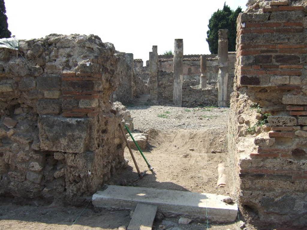 VI.2.19 Pompeii. September 2005. Entrance doorway, looking west.
According to Garcia y Garcia, two bombs fell here that caused the grave ruin and abandonment of the area. The prothyron was destroyed, two rooms to the south of it, and a part of the atrium. The north perimeter wall was also destroyed for a large area of 4 x 4m. See Garcia y Garcia, L., 2006. Danni di guerra a Pompei. Rome: L’Erma di Bretschneider. (p.74)