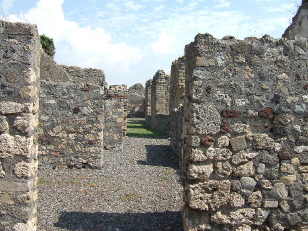 VI.5.2 Pompeii. September 2005. Looking east. According to Fiorelli, this shop had a hearth at the rear, together with a passage to the garden of the neighbouring house. It also had various rooms for the dwelling, or for the use of its industry. What ever that was, it cannot now be known with certainty, being as this structure was entirely destroyed. See Pappalardo, U., 2001. La Descrizione di Pompei per Giuseppe Fiorelli (1875). Napoli: Massa Editore. (p.53)