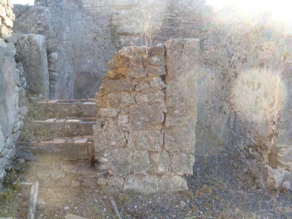 VI.5.9 Pompeii. May 2011. Looking west from south-west corner of atrium, towards stairs to upper floor and doorway to cubiculum.
