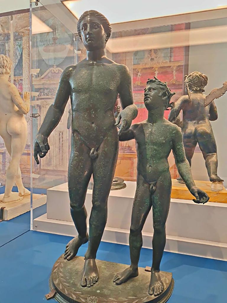 VI.6.1 Pompeii. October 2023.
Bronze and silver statue of Dionysos and a Satyr, inv. 4995. Photo courtesy of Giuseppe Ciaramella.
On display in “L’altra MANN” exhibition, October 2023, at Naples Archaeological Museum.