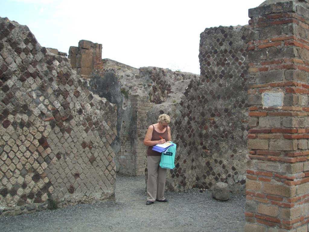 VI.6.17 Pompeii. May 2005. Looking towards south-east corner of entrance room or vestibule.
Looking towards doorway to rear small room linking with VI.6.20/21.
According to Boyce and Fiorelli, on a wall of the room entered at number 17 was painted a serpent and beneath it a tile projected for offerings.
See Boyce G. K., 1937. Corpus of the Lararia of Pompeii. Rome: MAAR 14. (p.47, no.158)
See Pappalardo, U., 2001. La Descrizione di Pompei per Giuseppe Fiorelli (1875). Napoli: Massa Editore. (p.56)
According to Stefani, the lararium was found on the west wall of VI.6.20. (see VI.6.20 and 21).
See Stefani, G. (2005): Pompei. Un Panificio: in Cibi e Sapori a Pompei e dintorni, (p.139).