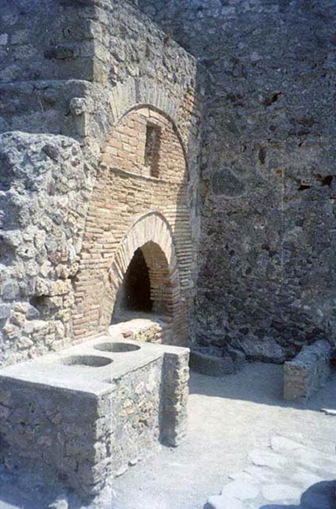 VI.6.17 Pompeii. July 2011. Bench, oven, and mill in bakery.
Photo courtesy of Rick Bauer.
