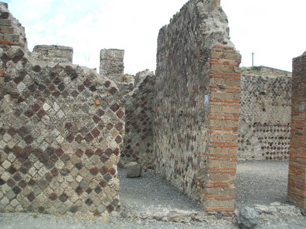 VI.6.18 Pompeii. May 2005. Looking west towards entrance doorway, in centre.  According to Della Corte, CIL IV 138, was found above one of the external pilasters in the south-west corner of insula VI.6.
See Della Corte, M., 1965.  Case ed Abitanti di Pompei. Napoli: Fausto Fiorentino. (p.113)
Fiorelli would appear to agree with Della Corte, as he said the advertisement was found on the walls of VI.6.18/19.
See Pappalardo, U., 2001. La Descrizione di Pompei per Giuseppe Fiorelli (1875). Napoli: Massa Editore. (p.56)
According to Mau, this public advertisement of a building to rent had now faded and vanished. The insula named after Arrius Pollio was thought by Fiorelli to be the so-called House of Pansa, across the street from the block on which the advertisement was found.  The identification may be correct � but a notice painted in so prominent a place might refer to a block in any part of the city. Mau�s translation was -
�To rent from the first day of next July, shops with the floors over them, fine upper chambers, and a house in the Arrius Pollio block owned by Gnaeus Alleius Nigidius Maius.  Prospective lessees may apply to Primus, slave of Gnaeus Alleius Nigidius Maius�.
See Mau, A., 1907, translated by Kelsey, F. W., Pompeii: Its Life and Art. New York: Macmillan. (p. 489).
According to Epigraphik-Datenbank Clauss/Slaby (See www.manfredclauss.de), it read as -
Insula Arriana 
Polliana Gn(aei!) Al<le=IF>i Nigidi Mai 
locantur ex <K=I>(alendis) Iuli(i)s primis tanernae 
cum pergulis suis et c{o}enacula 
equestria et domus conductor(is) 
convenito Primum Gn(aei) Al<le=IF>i 
Nigidi Mai ser(vum)      [CIL IV 138]


