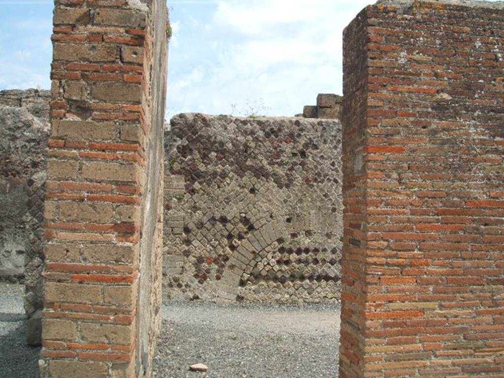 VI.6.19 Pompeii. May 2005. Looking west towards entrance doorway, in centre.  According to Della Corte, CIL IV 138, was found above one of the external pilasters in the south-west corner of insula VI.6.
See Della Corte, M., 1965.  Case ed Abitanti di Pompei. Napoli: Fausto Fiorentino. (p.113)  Fiorelli would appear to agree with Della Corte, as he said the advertisement was found on the walls of VI.6.18/19.
See Pappalardo, U., 2001. La Descrizione di Pompei per Giuseppe Fiorelli (1875). Napoli: Massa Editore. (p.56)
According to Mau, this public advertisement of a building to rent had now faded and vanished. The insula named after Arrius Pollio was thought by Fiorelli to be the so-called House of Pansa, across the street from the block on which the advertisement was found.  The identification may be correct � but a notice painted in so prominent a place might refer to a block in any part of the city. Mau�s translation was -
�To rent from the first day of next July, shops with the floors over them, fine upper chambers, and a house in the Arrius Pollio block owned by Gnaeus Alleius Nigidius Maius.  Prospective lessees may apply to Primus, slave of Gnaeus Alleius Nigidius Maius�.
See Mau, A., 1907, translated by Kelsey, F. W., Pompeii: Its Life and Art. New York: Macmillan. (p. 489).
According to Epigraphik-Datenbank Clauss/Slaby (See www.manfredclauss.de), it read as -
Insula Arriana 
Polliana Gn(aei!) Al<le=IF>i Nigidi Mai 
locantur ex <K=I>(alendis) Iuli(i)s primis tanernae 
cum pergulis suis et c{o}enacula 
equestria et domus conductor(is) 
convenito Primum Gn(aei) Al<le=IF>i 
Nigidi Mai ser(vum)      [CIL IV 138]

