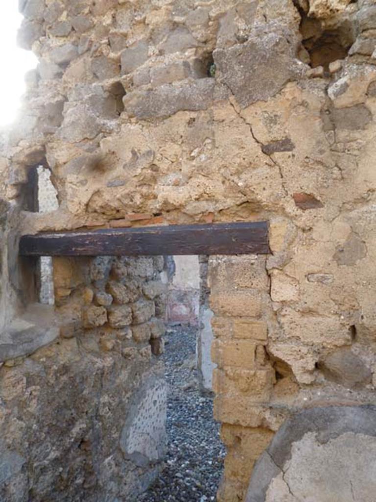 VI.7.1 Pompeii. May 2011. Doorway in north wall of small room or storeroom with remains of two vents.