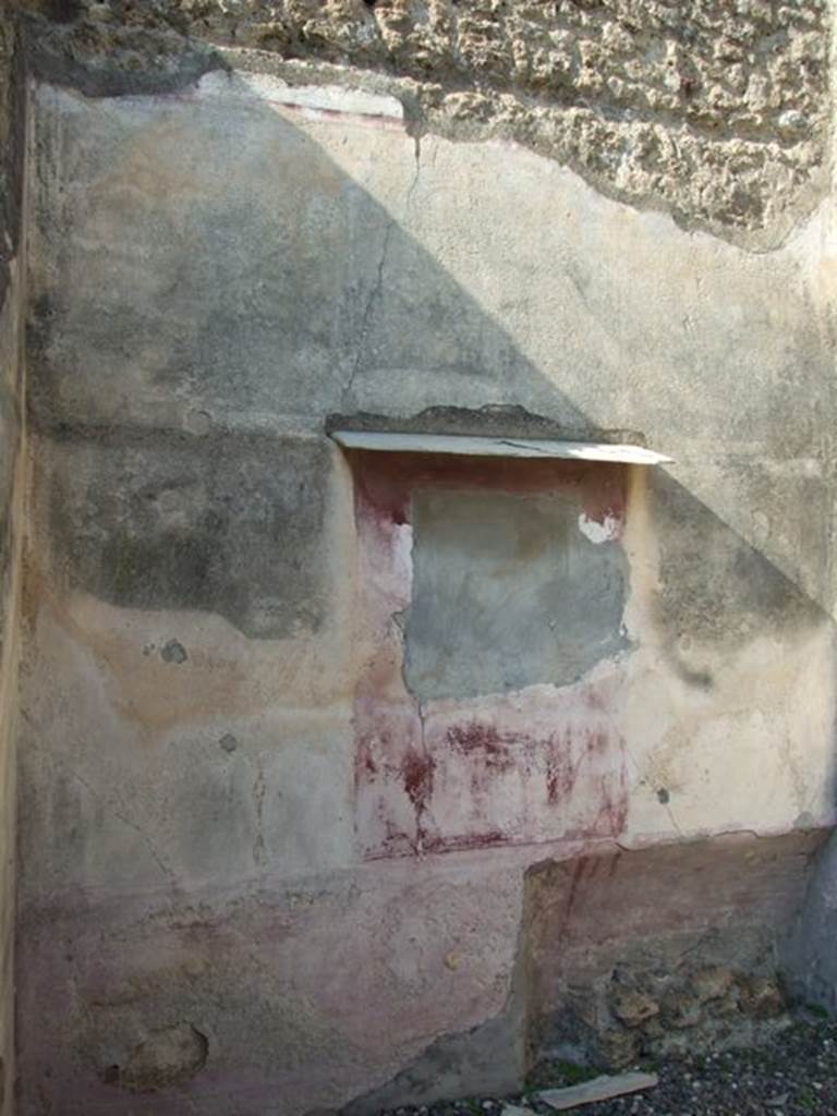 VI.7.3 Pompeii. March 2009. Room 4, remains of painting on north wall with bed recess below.
The zoccolo/lower wall was violet as was the central panel with the painting. The two side panels were discoloured.
