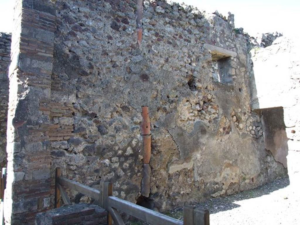 VI.7.5 Pompeii. March 2009. West wall with downpipe and site of VI.7.4 staircase to upper floor.