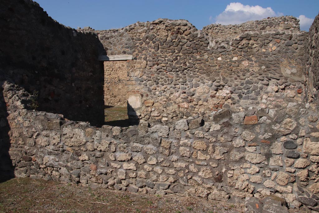 VI.7.13 and VI.7.14 Pompeii. October 2022.
Looking towards north wall of shop, with large room of VI.7.15, at rear. Photo courtesy of Klaus Heese.