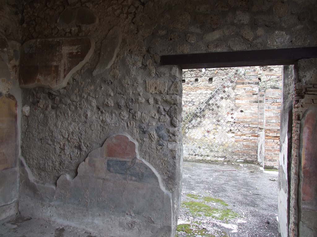 VI.7.18 Pompeii. December 2006. West wall and doorway of oecus to south of peristyle.