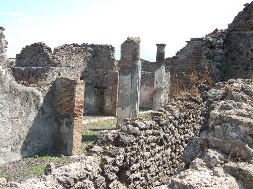 VI.7.20 Pompeii, September 2005. Looking south-east across triclinium towards peristyle.
On the left would be the east wall of the triclinium. Between the walls, in the lower right, would be east wall of the corridor leading to the kitchen and latrine. In the centre, between the pilasters, the south wall of the small room with the painted medallions can be seen, with doorway into corridor between atrium and peristyle. Taken over wall in Vicolo della Fullonica.