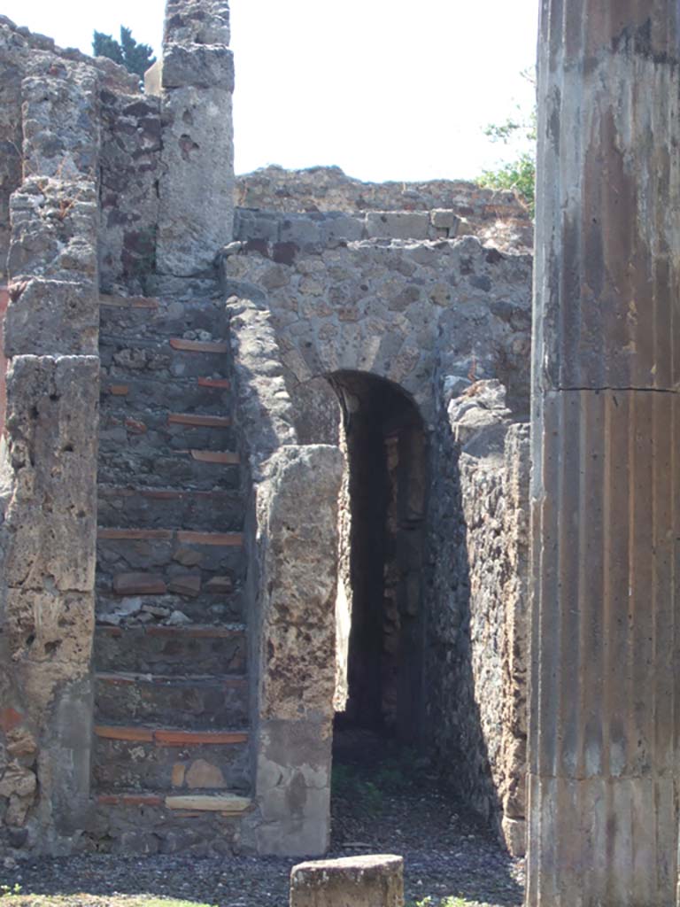 VI.7.21 Pompeii. September 2005.
Staircase to upper floor, and corridor through arch to rear and linking with peristyle of VI.7.20.