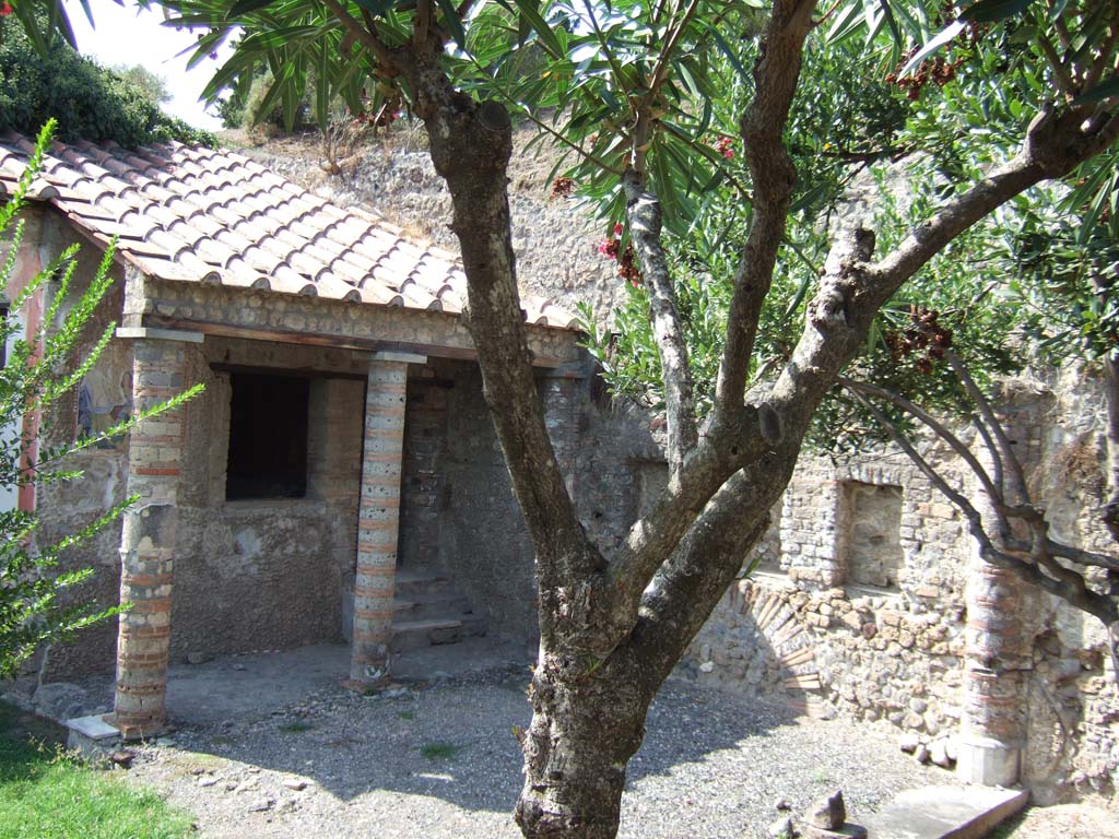 VI.7.23 Pompeii. September 2005. Site of summer triclinium with steps up to cubiculum decorated with mythology of Apollo.
According to E. Winsor Leach, on the north, south and east walls of the cubiculum are a series of paintings identifiable as events in the story of Marsyas.
3 phases of action on the north wall include Athena’s short-lived essay at flute playing and Marsyas performing before some of the Muses.
On the south wall are figures of Apollo and Olympus separated at the 2 ends of the couch. Finally, we see Marsyas bound to a tree.
The figures are framed within niches that seem to isolate their roles as participants in the drama.
See Leach, E. Winsor, 2004. The Social Life of Painting in Ancient Rome and on the Bay of Naples. Cambridge UK: Cambridge UP, p. 121.