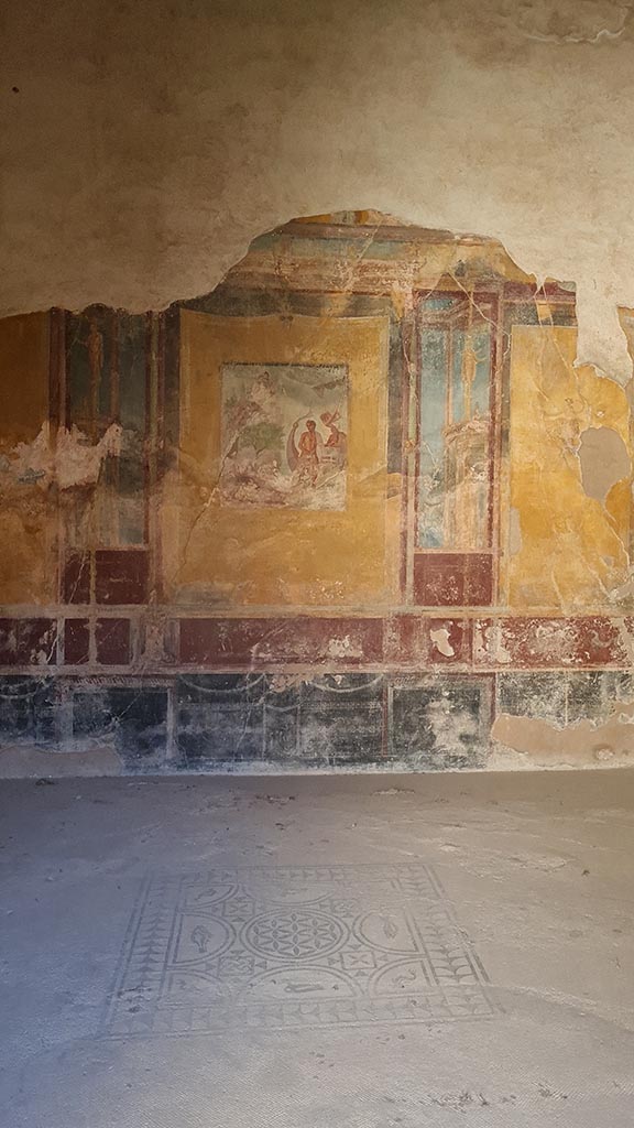 VI.8.3/5 Pompeii. October 2024.
Room 12, looking east across central emblema in floor towards east wall of dining room.
Photo courtesy of Giuseppe Ciaramella.