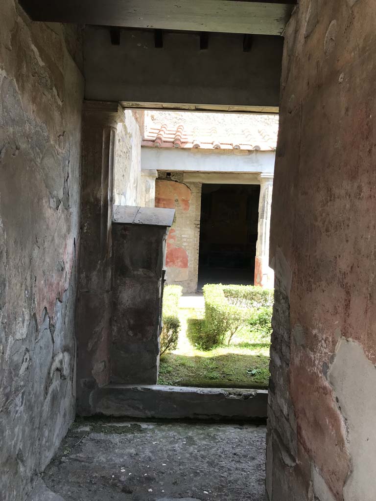 VI.8.3/5 Pompeii. April 2019.
Looking east along entrance corridor towards peristyle garden, from rear side doorway.
Photo courtesy of Rick Bauer.